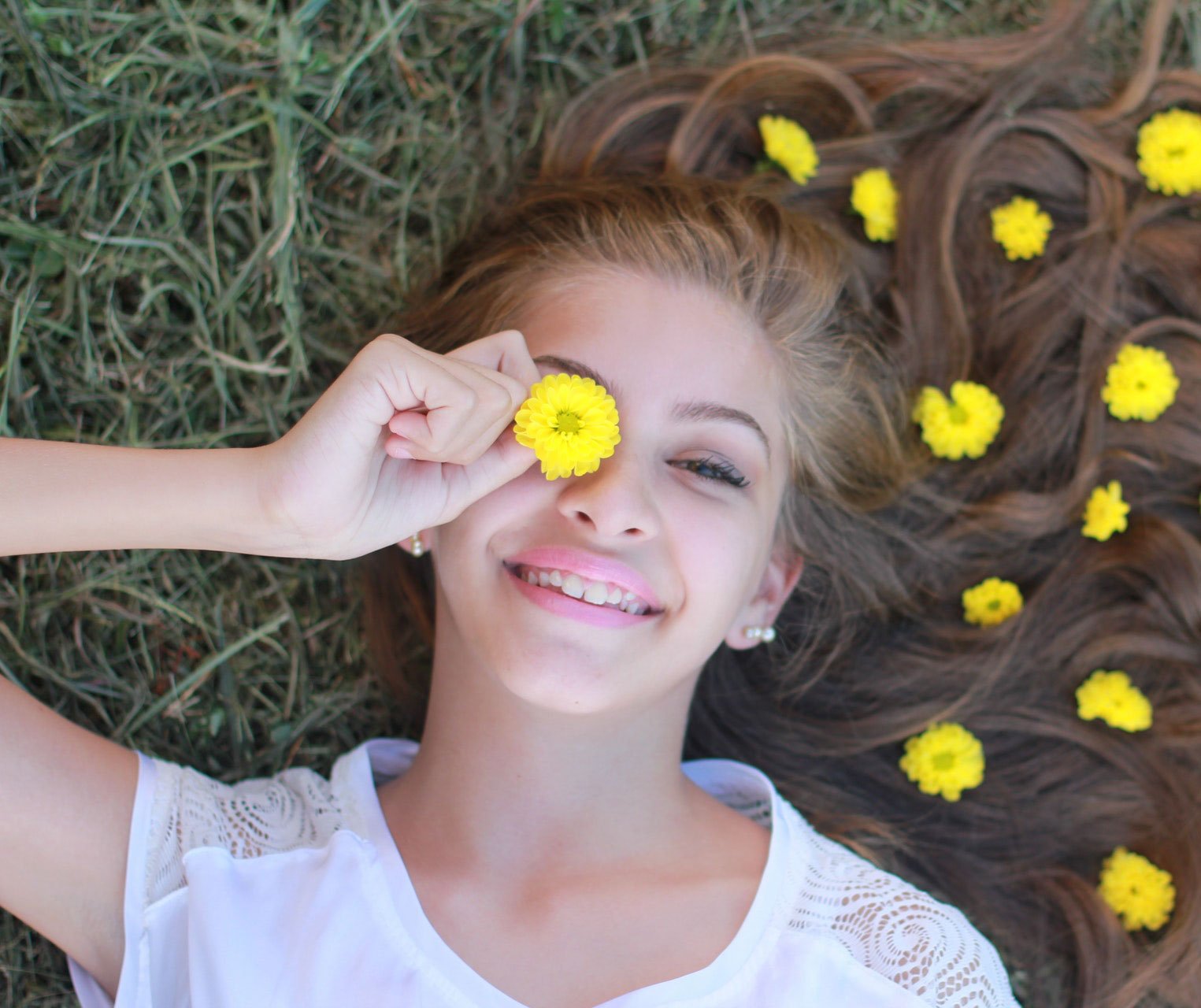 A young girl lying among the flowers.