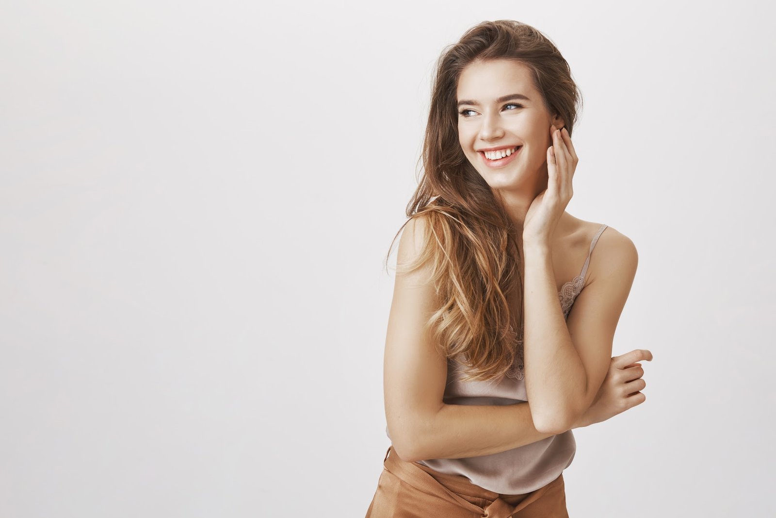 A mannequin poses. Smiling.