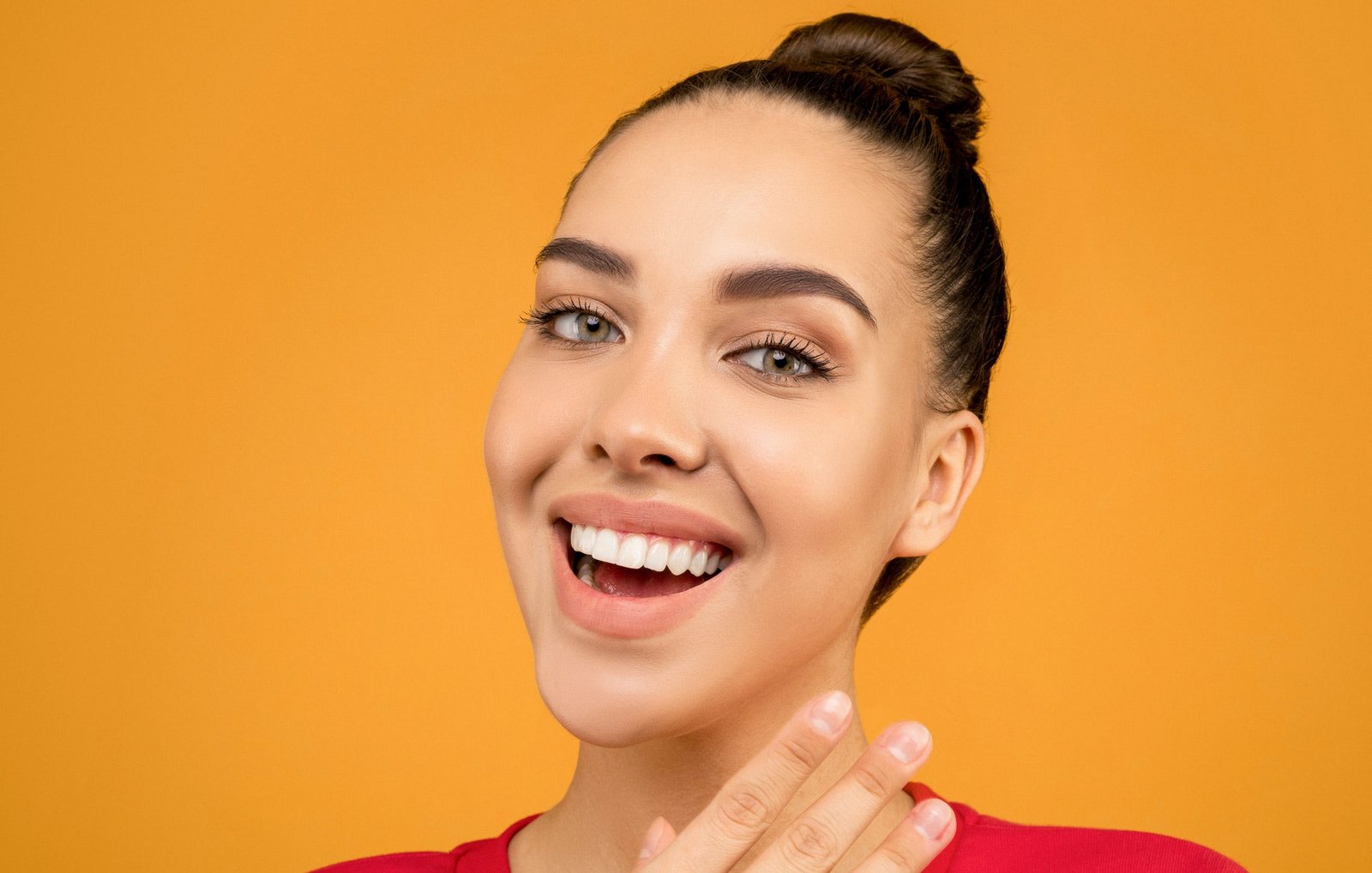 A lady undergoing aligner treatment. Smiling.