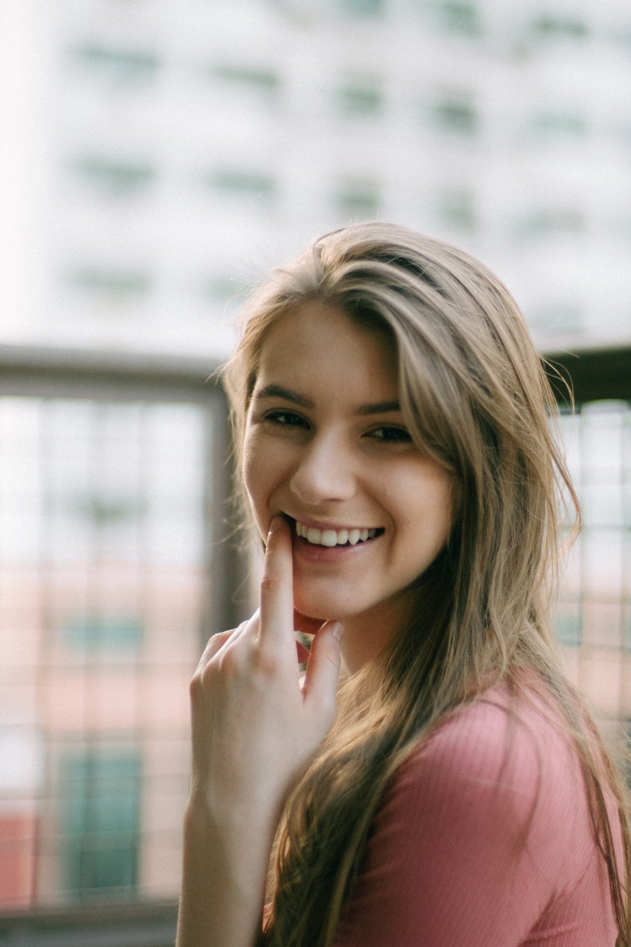 The middle general plan is a girl. She smiles to the left. Her teeth are healthy.
