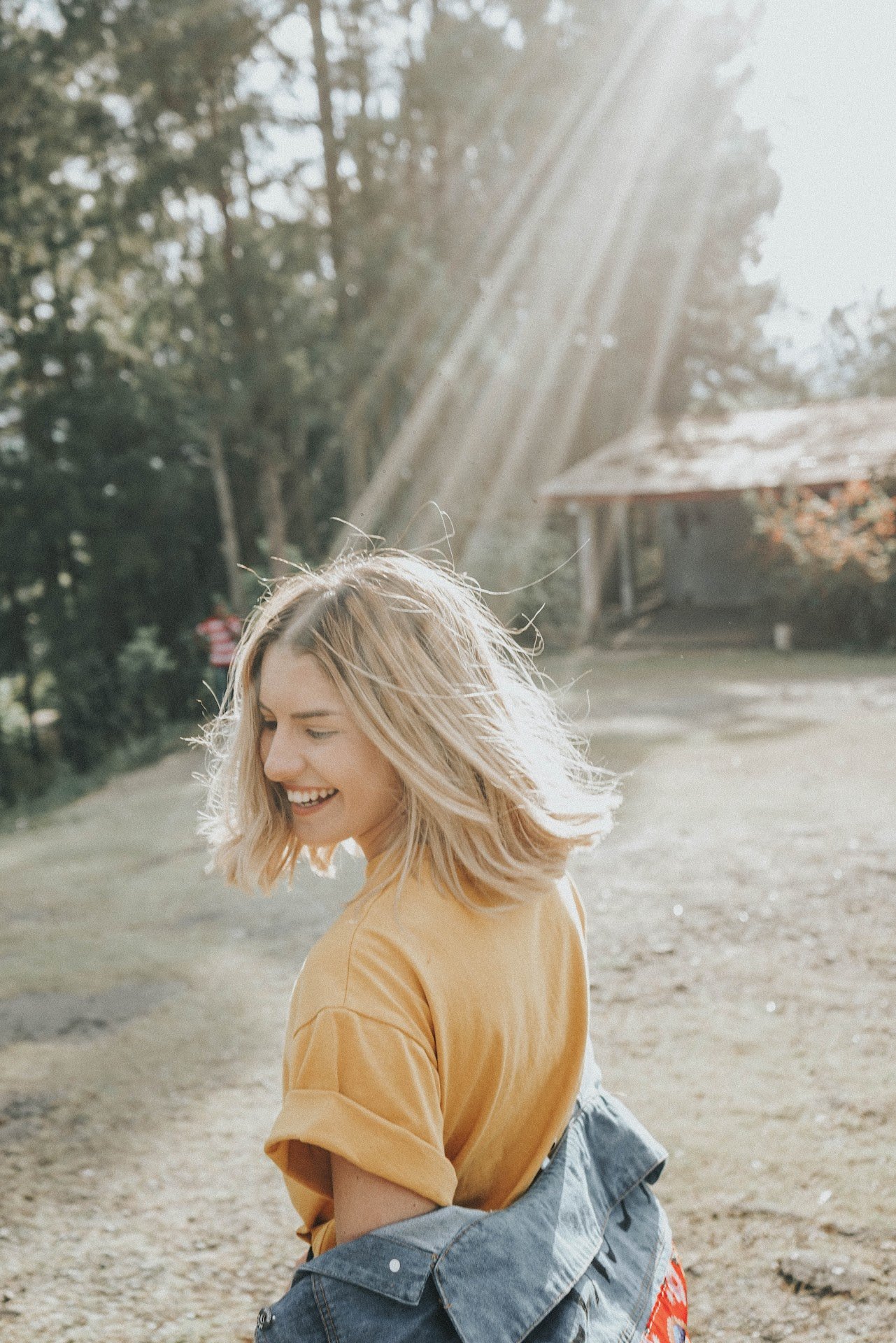 Face of a beautiful woman. Short hair. Smiling. Her upper teeth are visible.
