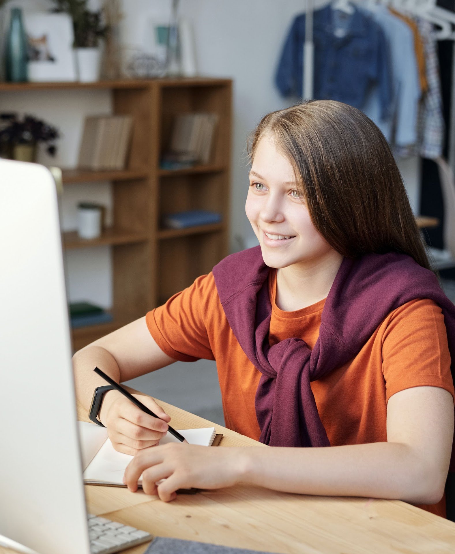 Close-up of a young girl doing research on the computer.